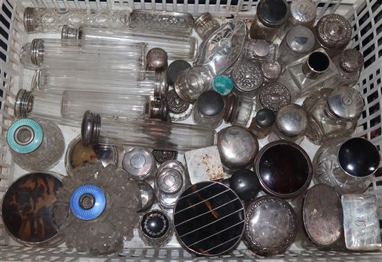 A large quantity of assorted silver topped toilet jars, scent bottles etc. including tortoiseshell and enamel.